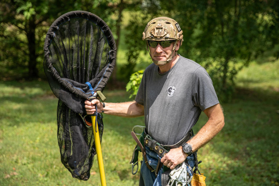 U.S. Air Force veteran Spencer Cocanour demonstrate his cat-rescue procedures at his home in Asheville on June 24, 2022.