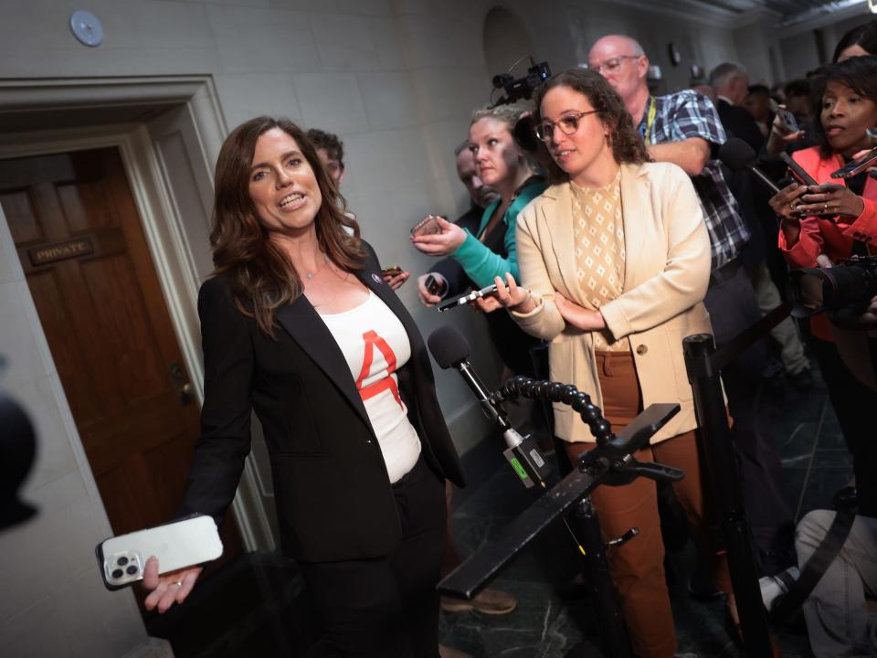 Rep. Nancy Mace speaks with reporters while wearing a bright red “A” across her shirt on October 10, 2023.