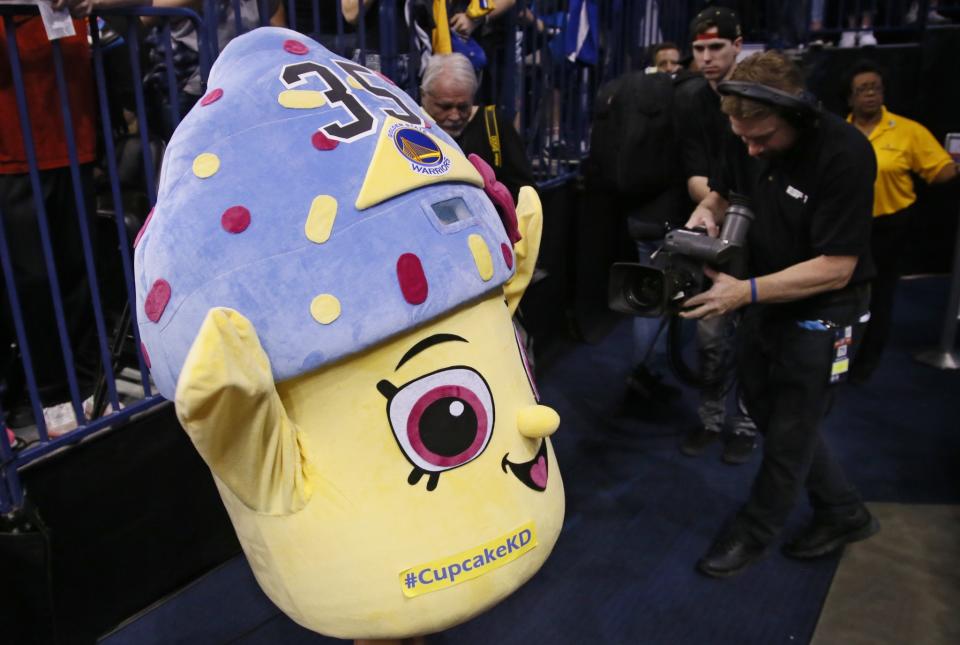 A young Thunder fan wears a cupcake costume before an NBA basketball game between the Golden State Warriors and the Oklahoma City Thunder in Oklahoma City, Saturday, Feb. 11, 2017. (AP/Sue Ogrocki)