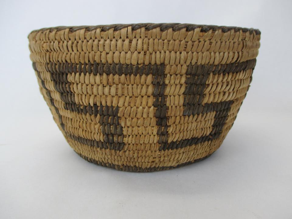 This larger basket features a typical geometric design and was likely used to carry fruits or grain from the field during the early 20th century.