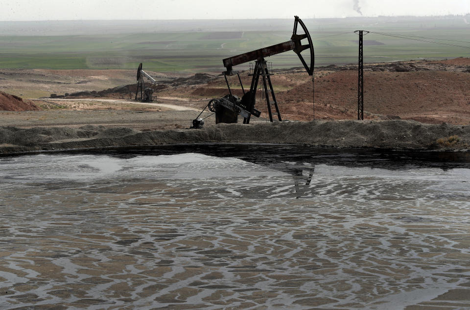 FILE - A pond of oil at an oil field controlled by a U.S-backed Kurdish group, in Rmeilan, Hassakeh province, Syria, March 27, 2018. Syria will host an Arab energy conference in 2024, the country's energy ministry said Thursday, Dec. 9, 2021, the latest sign that Arab countries are moving to re-engage with the government of Syria's embattled President Bashar Assad. (AP Photo/Hussein Malla, File)