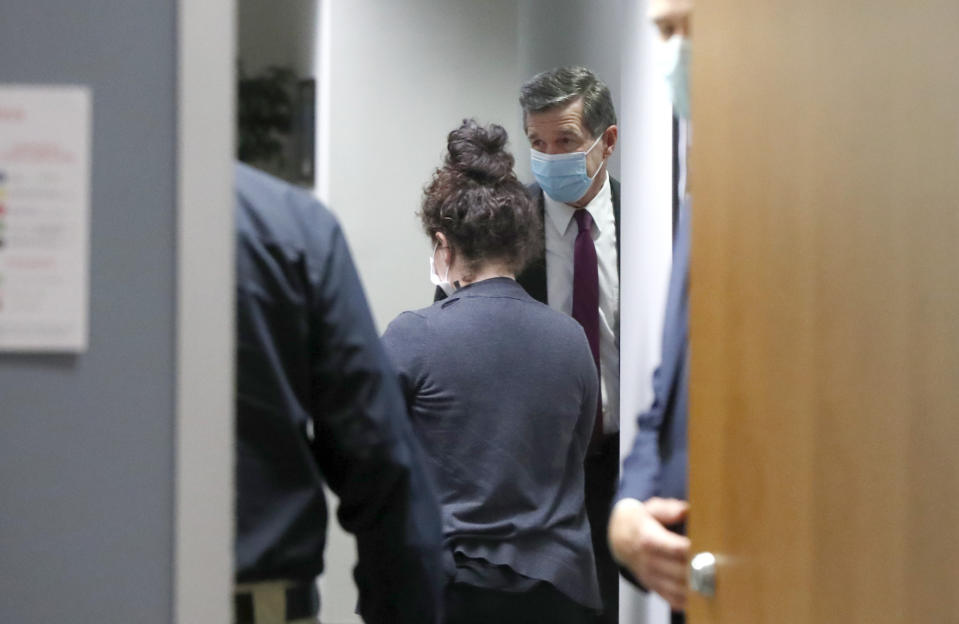 North Carolina Gov. Roy Cooper wears his mask after a media briefing on the coronavirus pandemic at the Emergency Operations Center in Raleigh, N.C., Thursday, May 28, 2020. (Ethan Hyman/The News & Observer via AP)