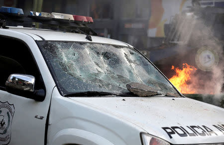 A police vehicle with a broken windshield is seen during a demonstration against a possible change in law to allow for presidential re-election in front of the Congress building in Asuncion, Paraguay, March 31, 2017. REUTERS/Jorge Adorno