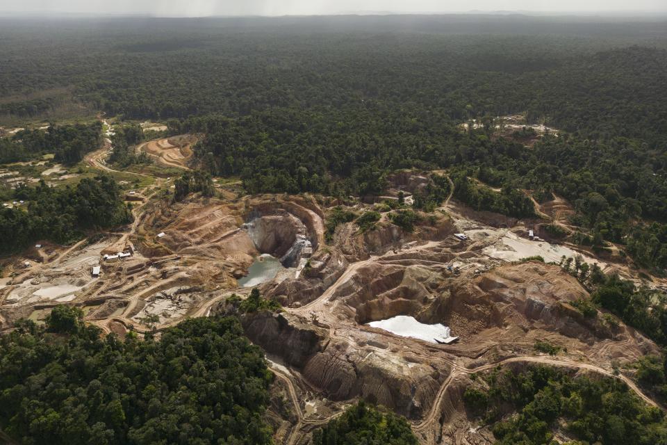 The Tassawini Gold Mines are visible amid trees in Chinese Landing, Guyana, Monday, April 17, 2023. (AP Photo/Matias Delacroix)