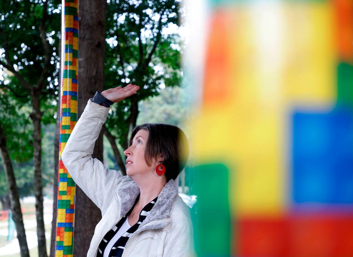 Emily Hardee, assistant principal at Brentwood Elementary School, stands in an outdoor walkway where colorful wrapping on poles covers chipped paint on Wednesday, Oct. 12, 2022, in Raleigh, N.C. Brentwood Elementary is one of seven schools that would undergo renovations in a $530.7 million bond referendum on the Nov. 8 ballot.