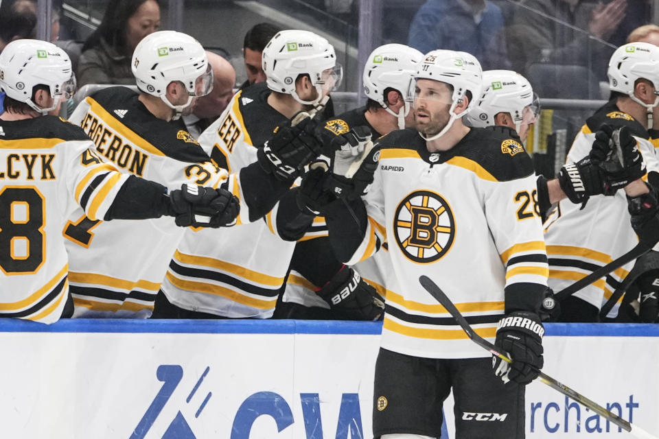 Boston Bruins' Derek Forbort (28) celebrates with teammates after scoring a goal during the second period of an NHL hockey game against the New York Islanders Wednesday, Jan. 18, 2023, in Elmont, N.Y. (AP Photo/Frank Franklin II)