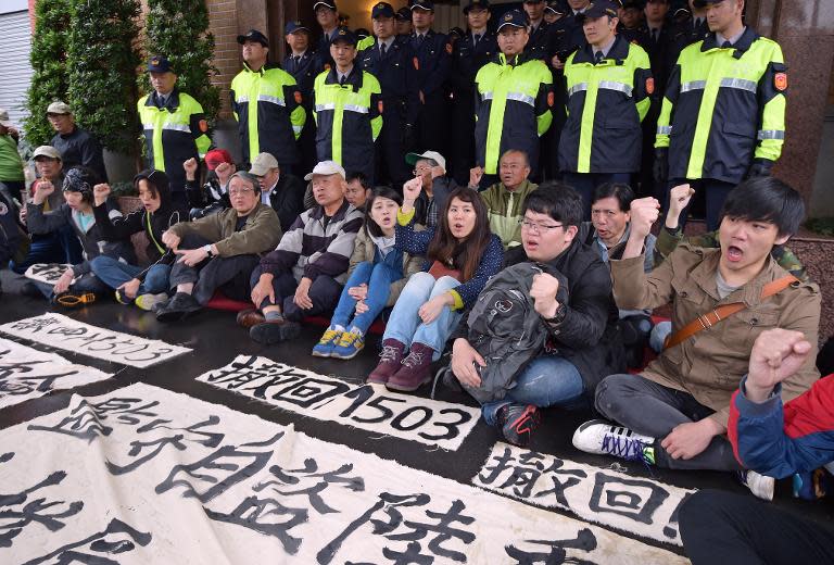 Pro-Taiwan independence activists display banners that read "oppose the M503", in reference to a proposed new Chinese flight route, at the Parliament in Taipei on March 27, 2015