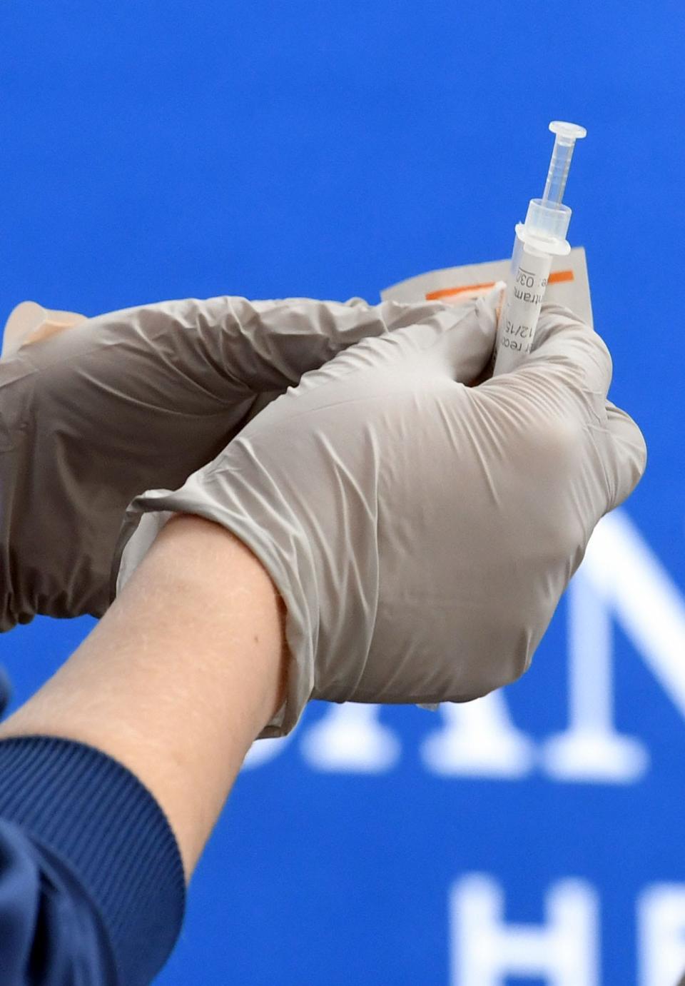 Registered nurse Paige Metz prepares a COVID-19 vaccine at Sanford Imagenetics in Sioux Falls, S.D..