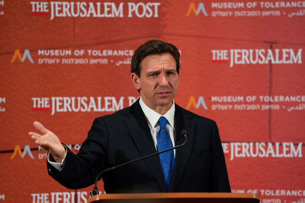 Gov. Ron DeSantis talks to the media at a conference titled "Celebrate the Faces of Israel" at Jerusalem's Museum of Tolerance in April. One of the reporters in attendance questioned the governor about an interview given by a former Guantanamo prison detainee, who said he remembered DeSantis from his service as a JAG lawyer there.