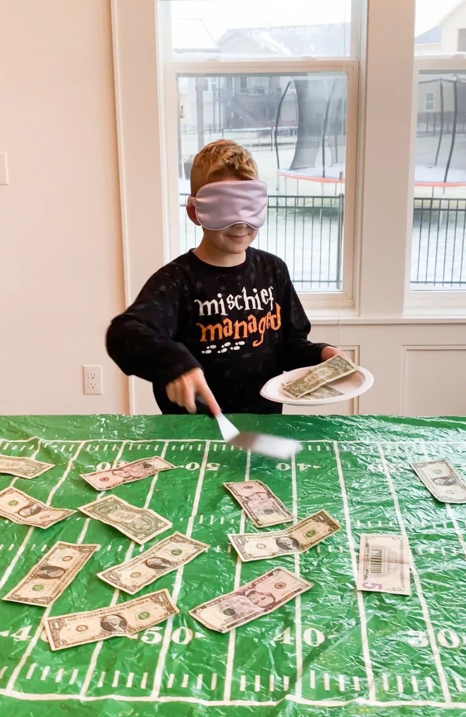 <p>This viral TikTok game is fun and easy to play. First, cover your table with $1 and $5 bills. Then, blindfold the player before giving them a spatula and a plate. Once you say go, they'll have 20 seconds to scoop as much money as they can onto the plate. <br></p><p><a href="https://www.playpartyplan.com/hilarious-super-bowl-party-games/" rel="nofollow noopener" target="_blank" data-ylk="slk:Get the tutorial at Party Play Plan »;elm:context_link;itc:0" class="link "><em>Get the tutorial at Party Play Plan »</em></a> </p>