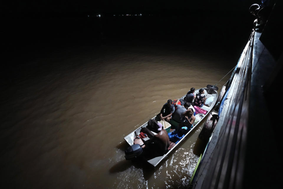 Passenger boats stopped at dawn in front of Vila Progresso community, on the island of Brique, in the Bailique Archipelago, district of Macapa, state of Amapa, northern Brazil, Friday, Sept. 9, 2022. Sea erosion is swallowing houses, schools and other facilities in the area. (AP Photo/Eraldo Peres)