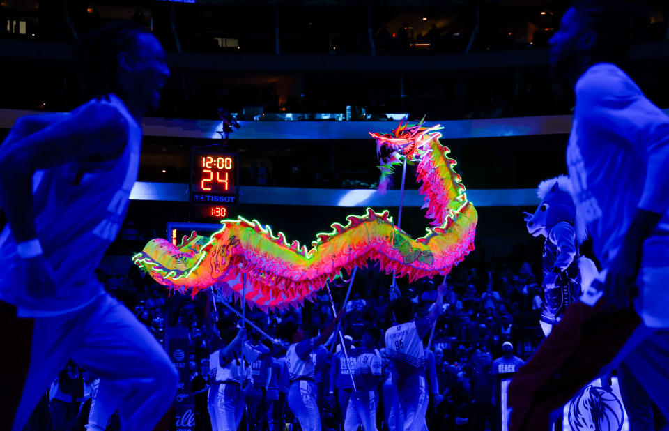 Feb 10, 2024; Dallas, Texas, USA; The Dallas Mavericks celebrate the Lunar New Year with performers as Oklahoma City Thunder players warm up before the game at American Airlines Center. Mandatory Credit: Kevin Jairaj-USA TODAY Sports
