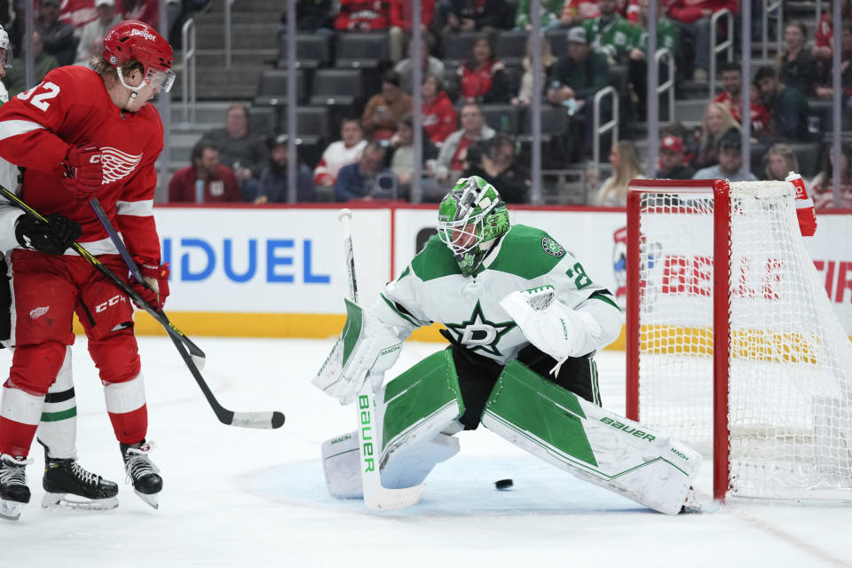 Detroit Red Wings right wing Jonatan Berggren (52) watches a David Perron shot beat Dallas Stars goaltender Jake Oettinger (29) in the second period of an NHL hockey game Monday, April 10, 2023, in Detroit. (AP Photo/Paul Sancya)