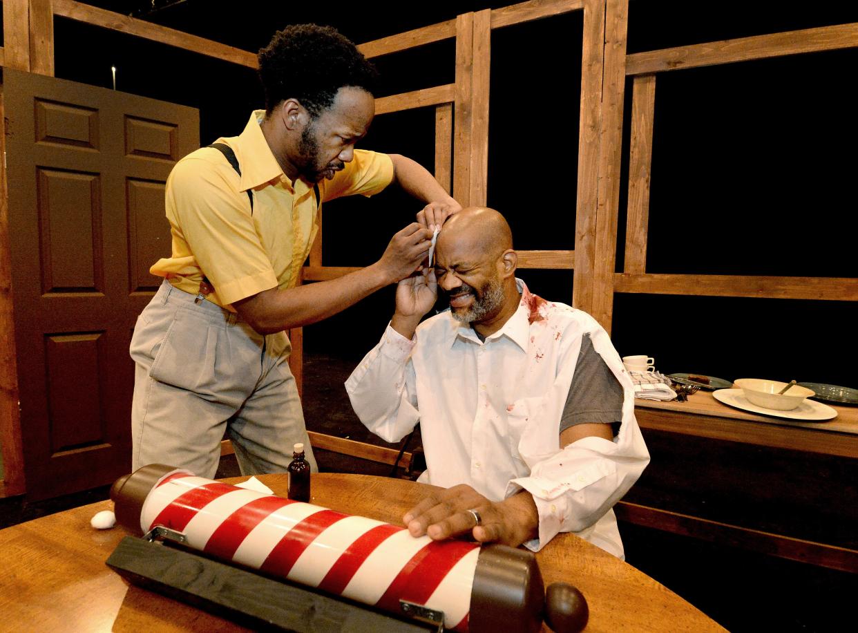 Reggie Guyton, left, as Wilford Pooks, and Kess Roberson as Henry Wilson rehearse "Outrage: Terror in Springfield 1908" at University of Illinois Springfield Studio Theatre. The original play about the Springfield Race Riot, written by Tim Crawford, will be staged Friday through Sunday.