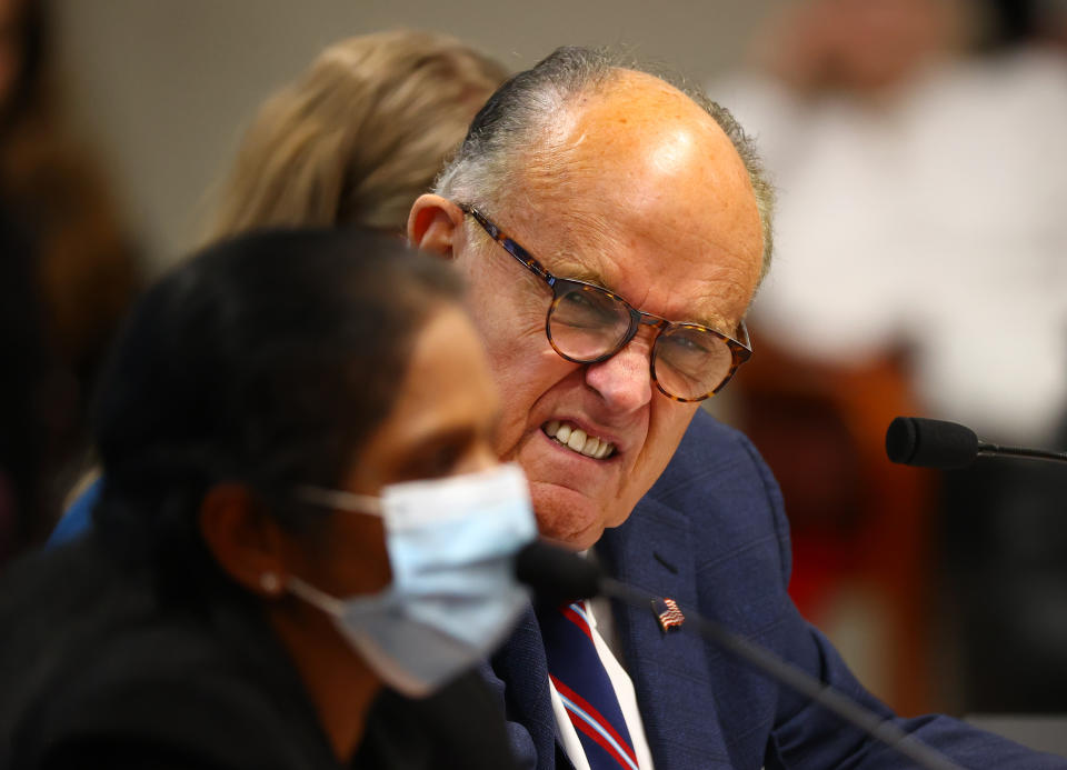President Donald Trump's personal attorney Rudy Giuliani listens to Detroit poll worker Jessi Jacobs during an appearance before the Michigan House Oversight Committee on December 2, 2020 in Lansing, Michigan. (Rey Del Rio/Getty Images)
