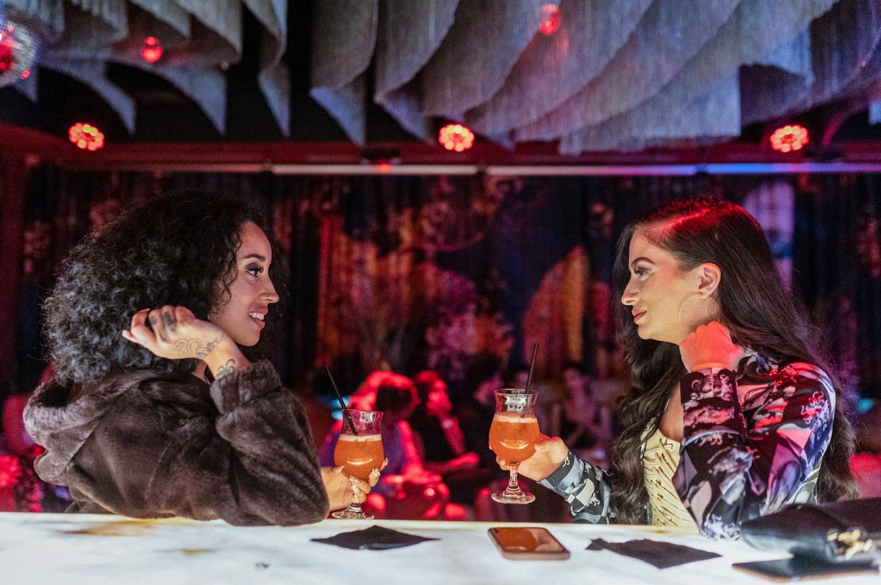 Milan Hayes, of Inkster, left, talks to Sarah Bodell, of Shelby Township, at the bar of Upstairs bar in downtown Detroit on Thursday, Oct. 26, 2023.