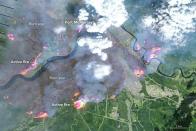 On May 4, 2016, the the Enhanced Thematic Mapper Plus (ETM+) on the Landsat 7 satellite acquired this false-color image of the wildfire that burned through Fort McMurray in Alberta, Canada. The image combines shortwave infrared, near infrared, and green light (bands 5-4-2). Near- and short-wave infrared help penetrate clouds and smoke to reveal the hot spots associated with active fires, which appear red. Smoke appears white and burned areas appear brown. THE CANADIAN PRESS/NASA Earth Observatory, Joshua Stevens