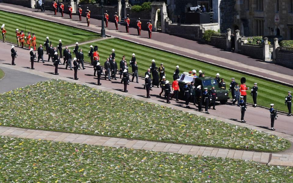 The Duke of Edinburgh's coffin, covered with his Personal Standard, is carried on the purpose built Land Rover Defender - Justin Tallis/PA Wire