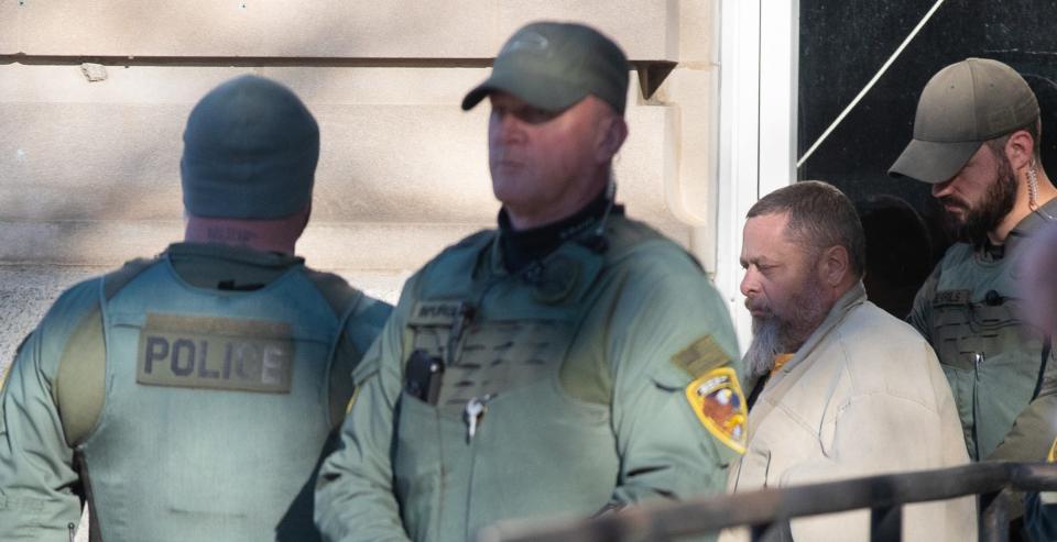 Officers transport murder suspect Richard Allen during a hearing regarding sealed documents, Tuesday, Nov. 22, 2022, at Carroll County Courthouse in Delphi, Ind.