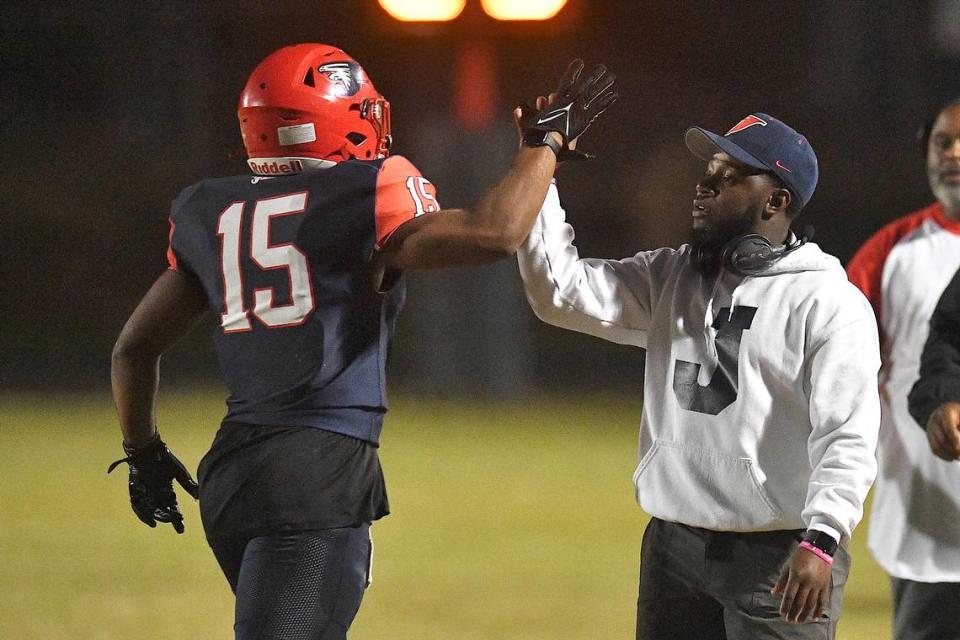 Jordan Assistant Coach Rahim Winston, Jr. congratulates running back Amareon Blue (15) after his first touchdown against Riverside. The Riverside Pirates and the Jordan Falcons met in a conference football game in Durham, N.C. on October 13, 2023.