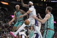 San Antonio Spurs' Jeremy Sochan (10) attempts to pass to teammate Jakob Poeltl (25) as he is defended by Los Angeles Lakers' Anthony Davis during the first half of an NBA basketball game Friday, Nov. 25, 2022, in San Antonio. (AP Photo/Darren Abate)