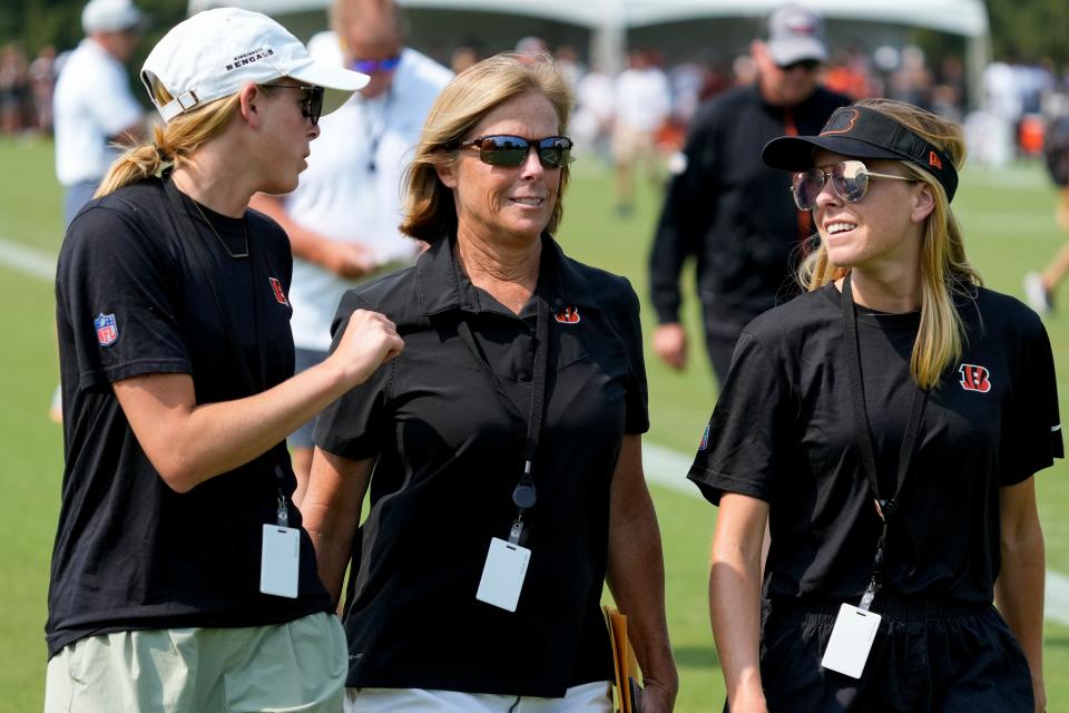 Bengals executive Vice President Katie Blackburn (center) walks off the practice field with her daughters Caroline and Elizabeth during a training camp practice at the Paycor Stadium practice facility in downtown Cincinnati on Tuesday, Aug. 1, 2023. Tuesday marked the team’s first preseason practice in pads.