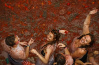 <p>Revellers enjoy the atmosphere in tomato pulp while participating the annual Tomatina festival on Aug. 30, 2017 in Bunol, Spain. (Photo: Pablo Blazquez Dominguez/Getty Images) </p>