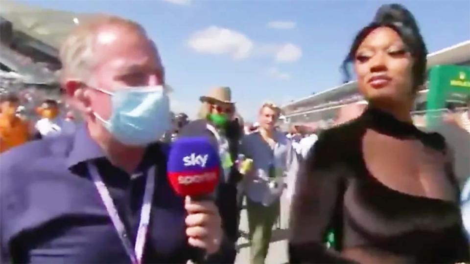 Martin Brundle (pictured left) trying to interview rapper Megan Thee Stallion on the F1 grid.