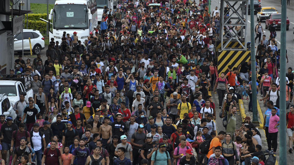 Crowds of Latin American migrants head toward the U.S. border.