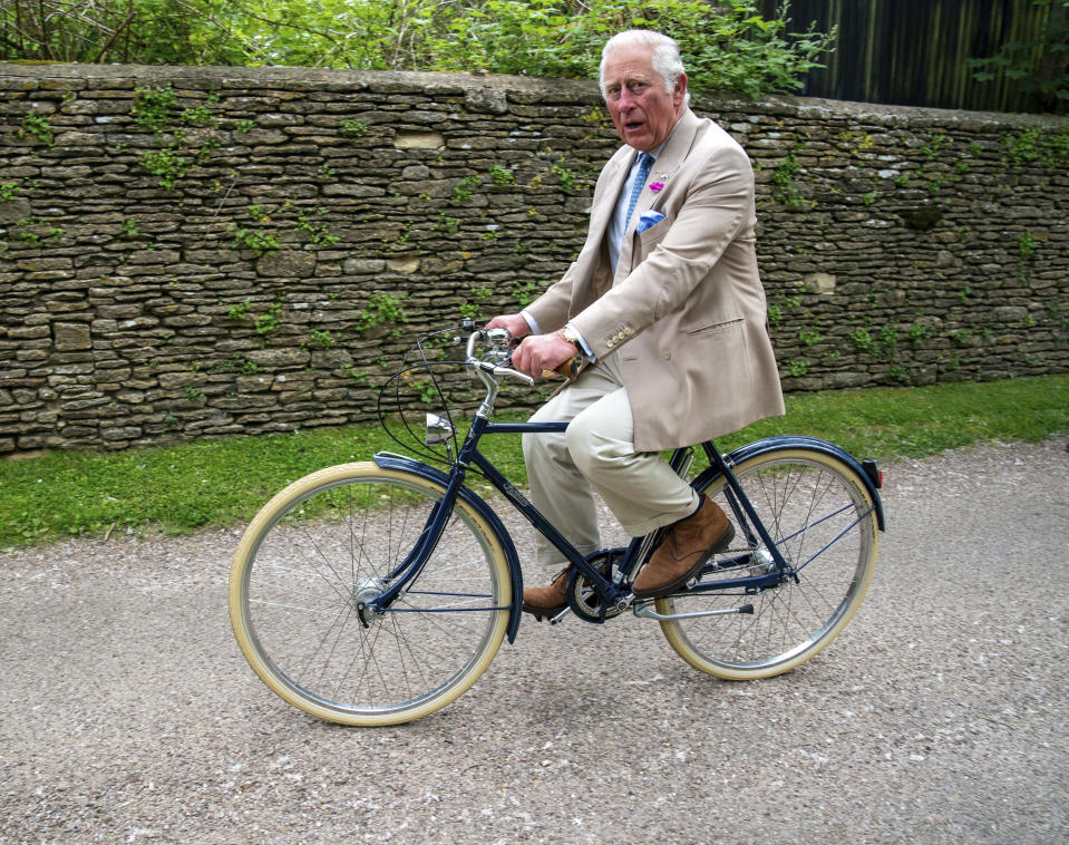FILE - In this June 10, 2021 file photo Britain's Prince Charles cycles with representatives of the British Asian Trust at Highgrove in Gloucestershire before they embark on the charity's 'Palaces on Wheels' cycling event, in England. Prince Charles has been preparing for the crown his entire life. Now, that moment has finally arrived. Charles, the oldest person to ever assume the British throne, became king on Thursday Sept. 8, 2022, following the death of his mother, Queen Elizabeth II. (Arthur Edwards/Pool Photo via AP, File)