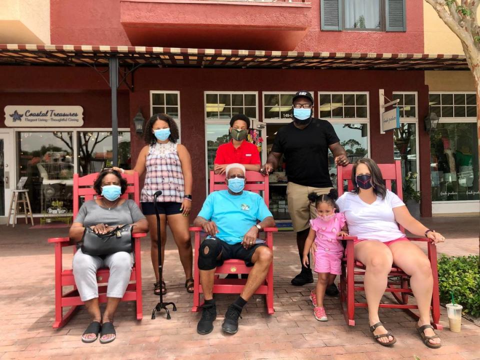 The Palmer Family from Raleigh, North Carolina sits in rocking chairs for a family photo. The three generations of family members wore masks inside and out on Hilton Head Island during their weeklong vacation during the coronavirus.