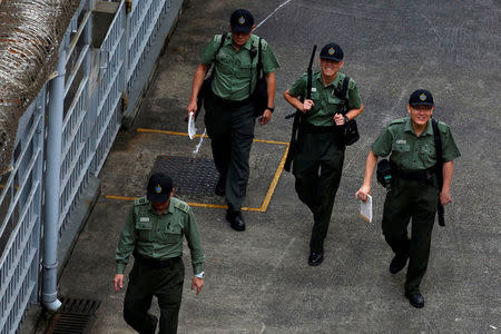 Armed Correctional Services Department officers walk inside Lai Chi Kok Reception Centre, where British former banker Rurik Jutting on a double murder trial is held, in Hong Kong, China November 3, 2016. REUTERS/Bobby Yip