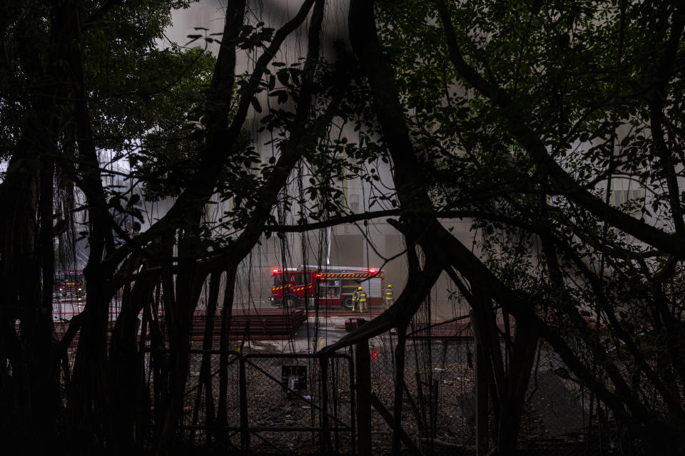 Firefighters battle a fire in Cheung Sha Wan, a residential and industrial area, in Hong Kong, Friday, March 24, 2023. (AP Photo/Louise Delmotte)