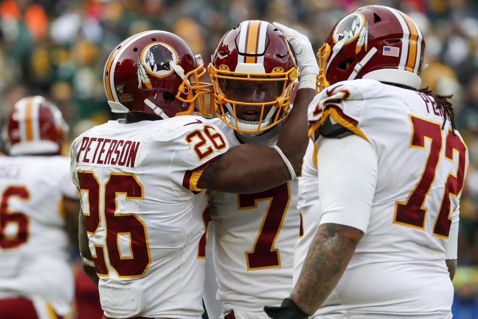 Washington Redskins' Adrian Peterson celebrates his touchdown run with Dwayne Haskins during the first half of an NFL football game against the Green Bay Packers Sunday, Dec. 8, 2019, in Green Bay, Wis. (AP Photo/Matt Ludtke)