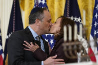 FILE - Vice President Kamala Harris and second gentleman Doug Emhoff kiss during an event in the East Room of the White House in Washington, to light the menorah to celebrate Hanukkah, on Dec. 1, 2021. (AP Photo/Susan Walsh, File)