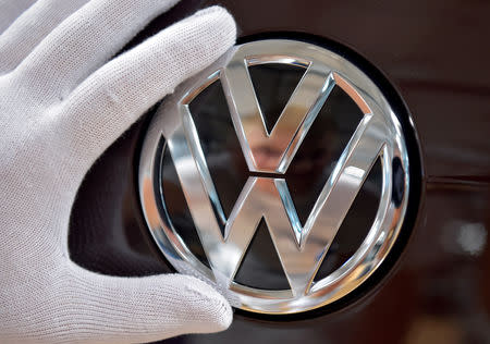 FILE PHOTO: Mechanic staff work on the production line of Volkswagen e-Golf in the Glaeserne Manufaktur plant in Dresden, Germany May 8, 2018. REUTERS/Matthias Rietschel/File Photo