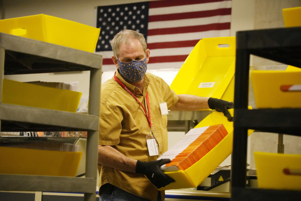 Sorter operator Ed Goddard moves a tray of processed early ballots in the Jefferson County elections division, Tuesday, Oct. 26, 2021, in Golden, Colo. Officials were highlighting the steps taken to ensure that the election is carried out seamlessly. (AP Photo/David Zalubowski)