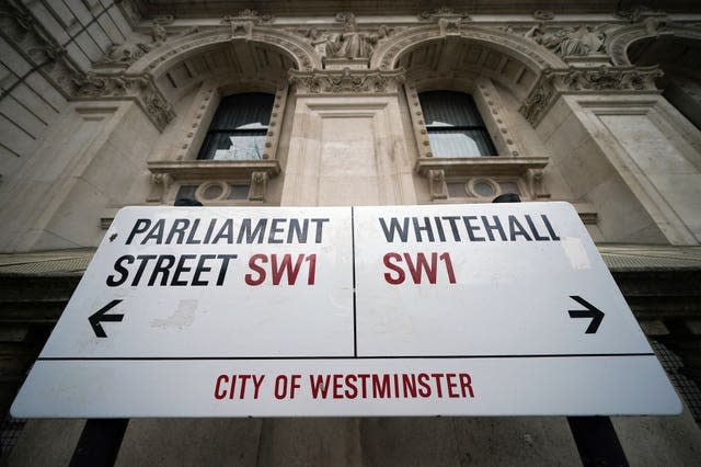 A road sign showing arrows in different directions for Parliament Street and Whitehall in London