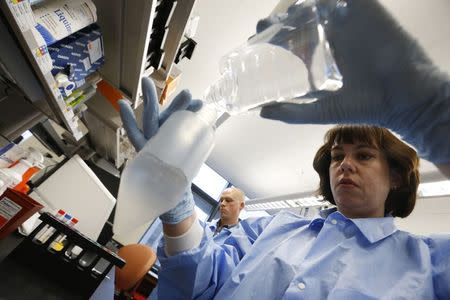 Molecular Genetics Technical Specialist Jaime Wendt (R) and Mike Tschannen work in the Human and Molecular Genetics Center Sequencing Core at the Medical College of Wisconsin in Milwaukee, Wisconsin, May 9, 2014. REUTERS/Jim Young