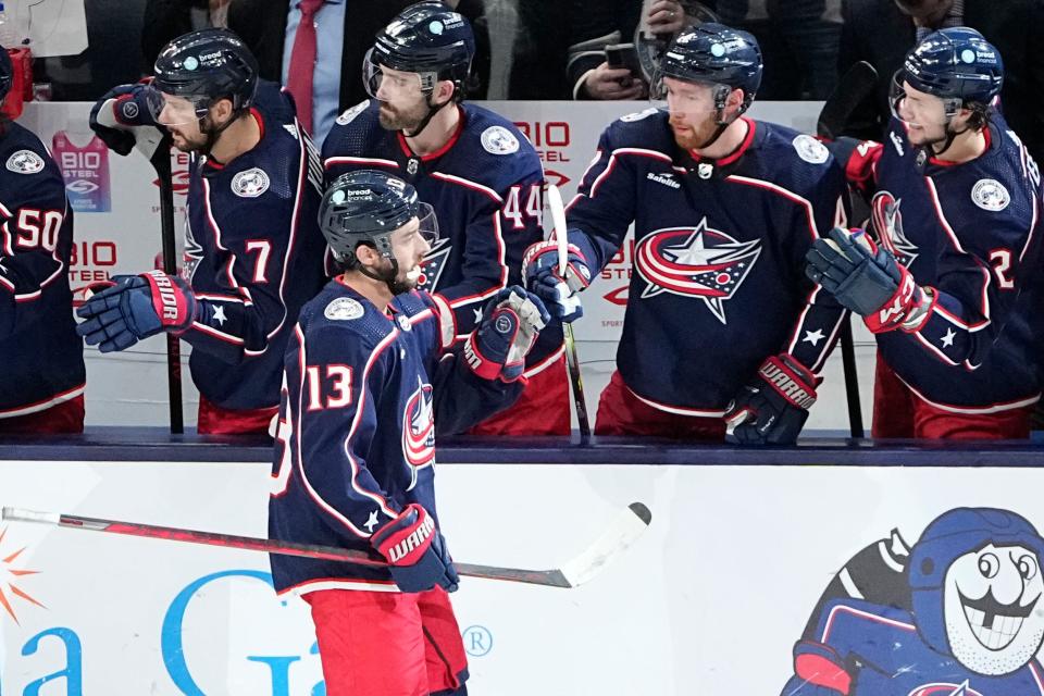 Jan 21, 2023; Columbus, Ohio, USA;  Columbus Blue Jackets left wing Johnny Gaudreau (13) gets high fives from the bench after scoring a goal during the second period of the NHL hockey game against the San Jose Sharks at Nationwide Arena. Mandatory Credit: Adam Cairns-The Columbus Dispatch