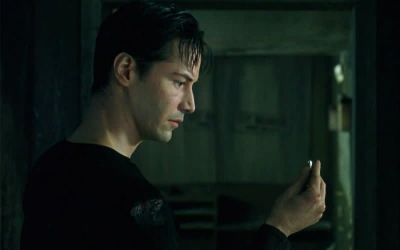 Neo from The Matrix holds a bullet in his hands