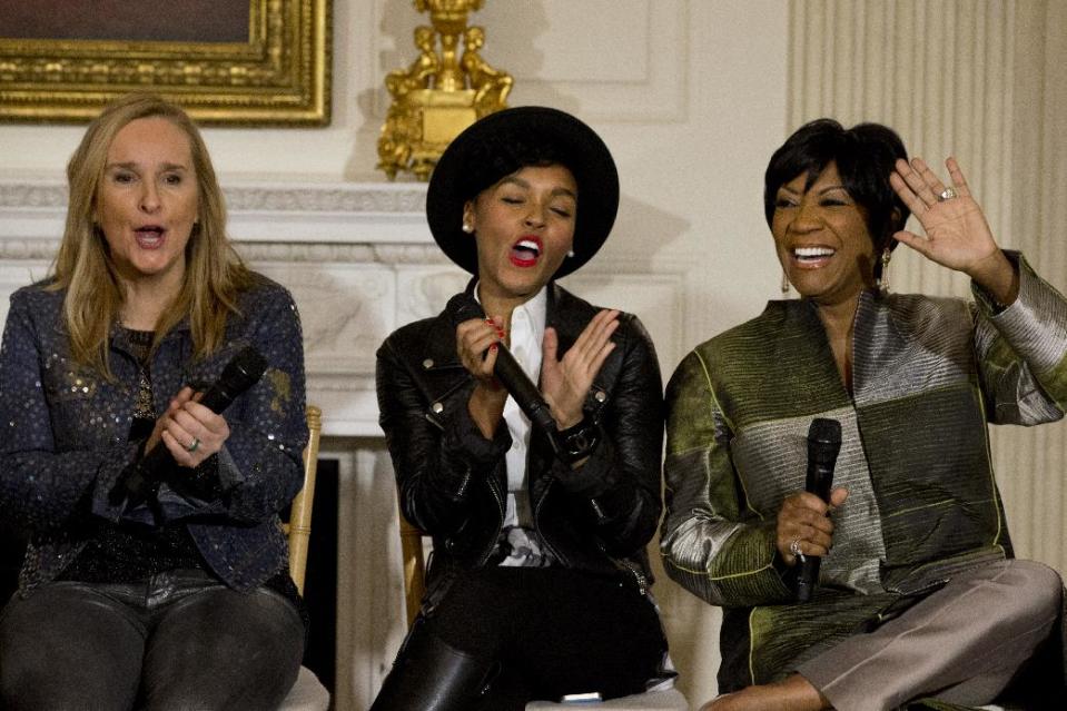 Singers Melissa Etheridge, left, and Janelle Monáe, applaud Patti LaBelle, right, as she is introduced in the State Dining Room of the White House Washington, Thursday, March 6, 2014, during a workshop for students as part of the “In Performance at the White House” series, celebrating female artists as the "foremothers” of American music, hosted by first lady Michelle Obama. (AP Photo/Jacquelyn Martin)