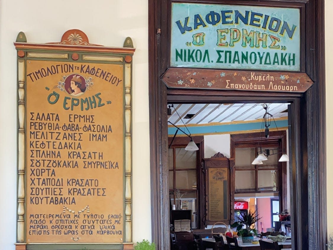 signs outside ermis kafeneio restaurant in greece