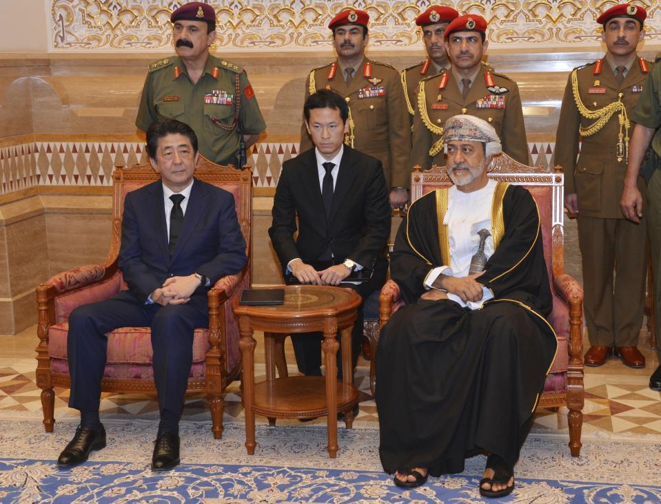 In this photo made available by Oman News Agency, Oman's Sultan Haitham bin Tariq Al Said, right, receives Japan's prime minister Shinzo Abe after his arrival in Muscat, Oman, Tuesday, Jan. 14, 2020. (Oman News Agency via AP)