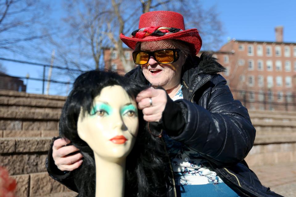 Audrey Burnett fashions one of her many wigs at Henry Law Park on Jan. 24, 2022 in Dover.