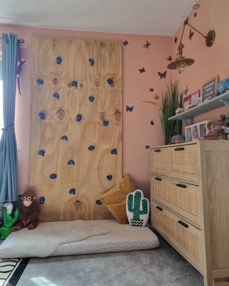 Wooden climbing wall in child's room.