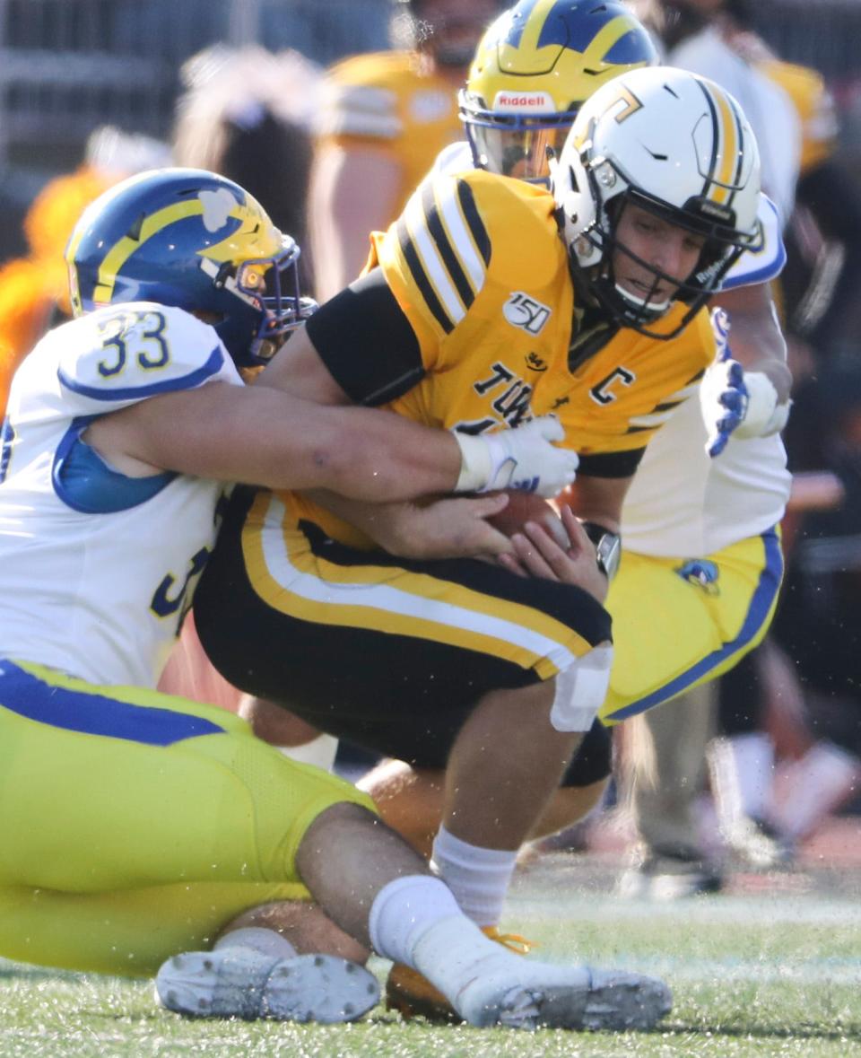 Delaware linebacker Johnny Buchanan hauls down Towson's Tom Flacco in the second quarter at Johnny Unitas Stadium in Towson, Md. Saturday.