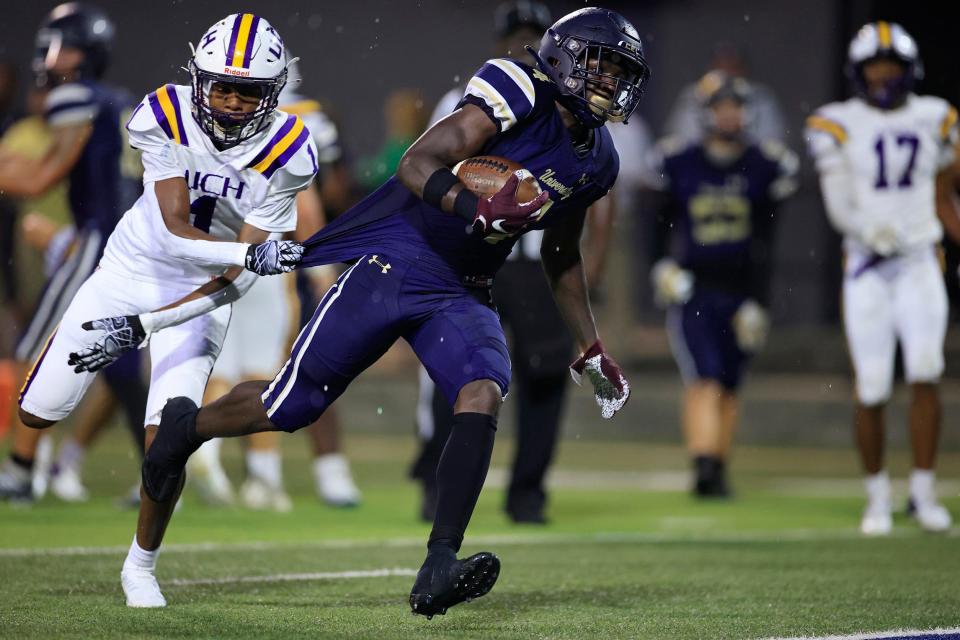 University Christian's Orel Gray #4 slips past Union County's Antrell Ross #1 en route to a touchdown score during the second quarter of a regular season high school football game Friday, Aug. 26, 2022 at University Christian School in Jacksonville. The University Christian Fightin' Christians defeated Union County Fightin' Tigers 33-14 after a 30 minute lightning delay at the end of the third quarter. 