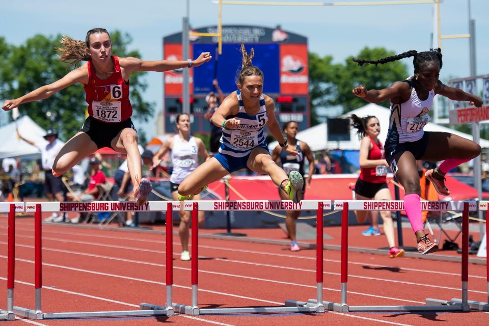 Spring Grove's Ella Bahn (center) leaps to a gold medal in the 3A 300-meter hurldes (42.62) at the PIAA Track and Field Championships at Shippensburg University Saturday, May 27, 2023.