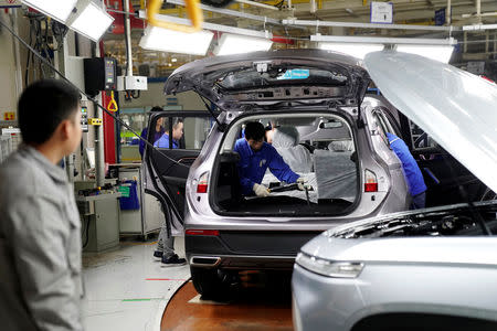 Employees work on Baojun RS-5 cars at a final assembly plant operated by General Motors Co and its local joint-venture partners in Liuzhou, Guangxi Zhuang Autonomous Region, China, February 28, 2019. REUTERS/Aly Song